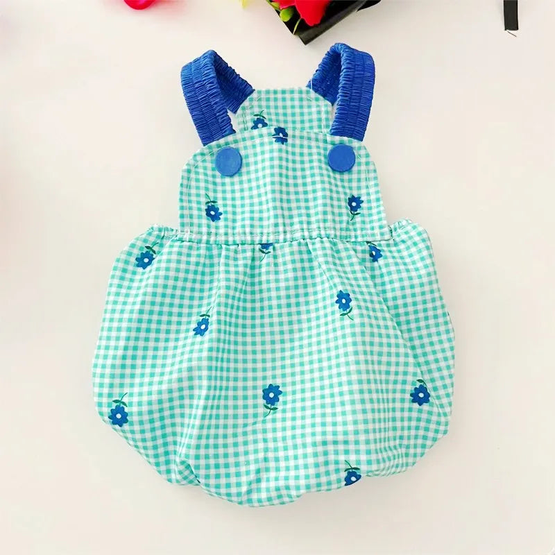 Light green gingham dog dress with blue floral embroidery and ruffled straps by PetoPop, front view with blue buttons and gathered skirt