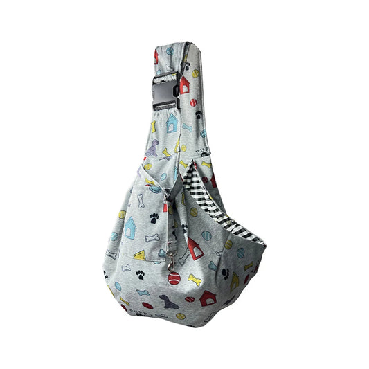 Gray printed pet carrier bag with colorful dog-themed pattern, black and white striped trim, adjustable shoulder strap, front pocket, and side view angle